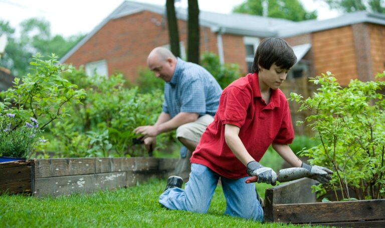 A senior farming with a young teenager